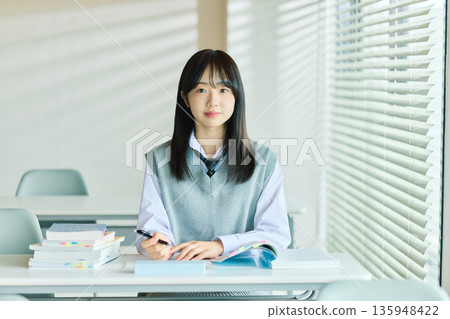 Female students taking classes Female students taking classes 135948422
