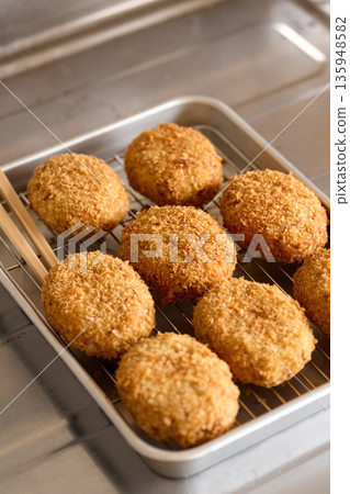 Freshly fried hot croquettes Freshly fried hot croquettes 135948582