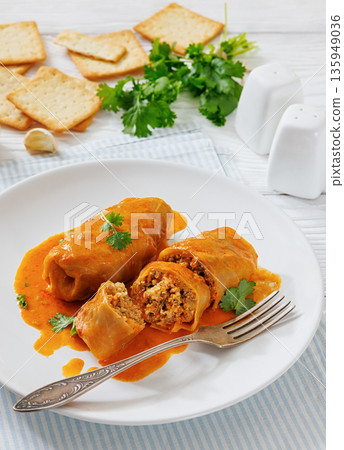 Stuffed cabbage rolls with quinoa and tomato sauce Stuffed cabbage rolls with quinoa and tomato sauce 135949036
