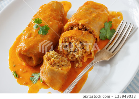 Stuffed cabbage rolls with quinoa and tomato sauce Stuffed cabbage rolls with quinoa and tomato sauce 135949038