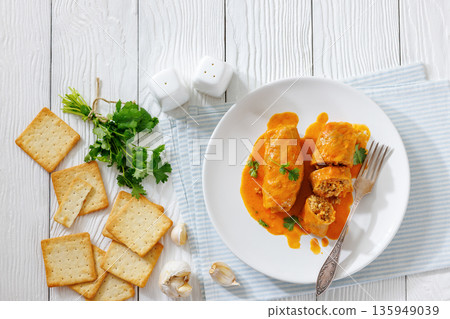 Stuffed cabbage rolls with quinoa and tomato sauce Stuffed cabbage rolls with quinoa and tomato sauce 135949039