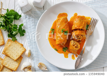 Stuffed cabbage rolls with quinoa and tomato sauce Stuffed cabbage rolls with quinoa and tomato sauce 135949040