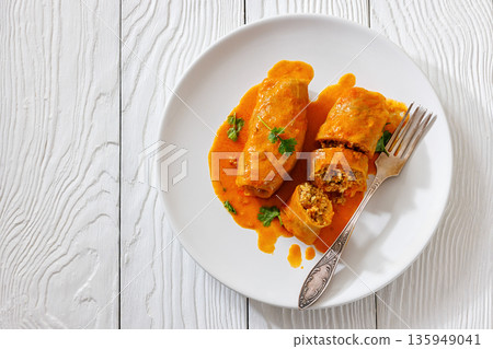 Stuffed cabbage rolls with quinoa and tomato sauce Stuffed cabbage rolls with quinoa and tomato sauce 135949041
