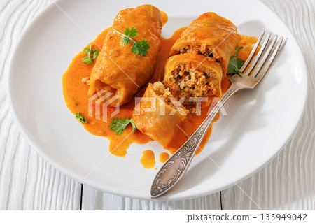 Stuffed cabbage rolls with quinoa and tomato sauce Stuffed cabbage rolls with quinoa and tomato sauce 135949042