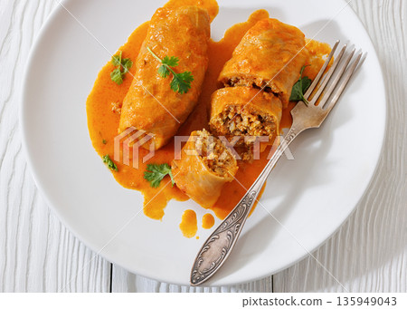 Stuffed cabbage rolls with quinoa and tomato sauce Stuffed cabbage rolls with quinoa and tomato sauce 135949043
