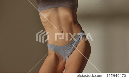 Female body close up in gray underwear in studio. 135949470