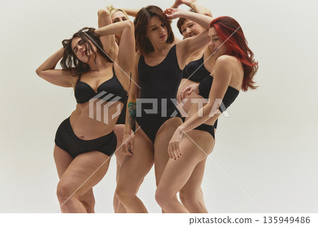 Diverse women posing naturally in black underwear in studio. Diverse women posing naturally in black underwear in studio. 135949486