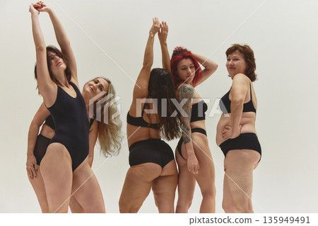 Women stretching bodies in black underwear in studio Women stretching bodies in black underwear in studio 135949491