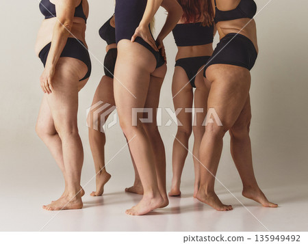 Women bodies back view in black underwear on studio background. Women bodies back view in black underwear on studio background. 135949492