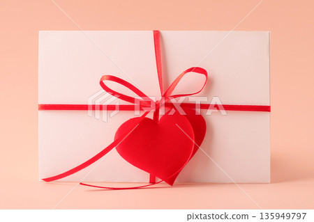Love letter envelope with red heart ribbon 135949797