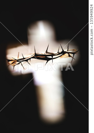 The crown of thorns and the cross, symbols of Jesus' sacrifice and suffering, are the background for the Easter poster during Lent and Holy Week. The crown of thorns and the cross, symbols of Jesus' sacrifice and suffering, are the background for the Easter poster during Lent and Holy Week. 135949924