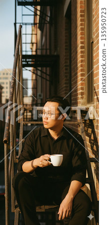 A cinematic, indie-style portrait of a man sitting on a rustic metal fire escape in New York's East Village. Asian man potrait image. High quality photo 135950723