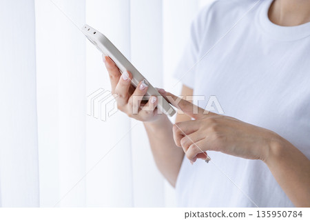Young woman using a smartphone Young woman using a smartphone 135950784