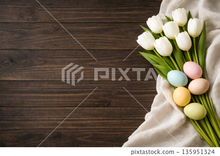White tulips and pastel Easter eggs on rustic wooden background with copy space 135951324