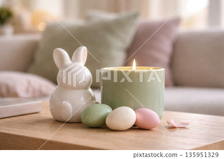 Cozy Easter home decor with ceramic bunny candle and pastel eggs on wooden table Cozy Easter home decor with ceramic bunny candle and pastel eggs on wooden table 135951329