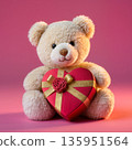 Teddy bear holding heart gift box on pink background for valentines day greeting card 135951564