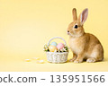 Cute Easter rabbit with pastel eggs in basket on yellow background 135951566