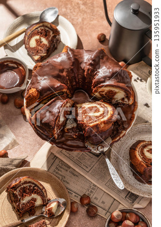 Chocolate marble bundt cake or zebra cake with chocolate glaze sliced on brown table background Chocolate marble bundt cake or zebra cake with chocolate glaze sliced on brown table background 135951933