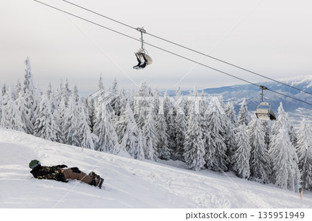 Chairlift over snowy forest in Poiana Brasov, Romania 135951949