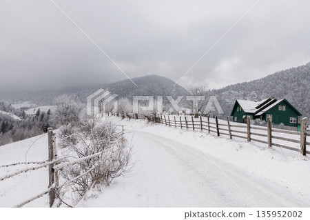 Snowy mountain village in winter, Carpathian Mountains, Romania Snowy mountain village in winter, Carpathian Mountains, Romania 135952002