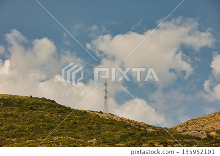 A sweeping mountain landscape in August 2025, with tiered, wooded hills under a clear summer sky. A sweeping mountain landscape in August 2025, with tiered, wooded hills under a clear summer sky. 135952101
