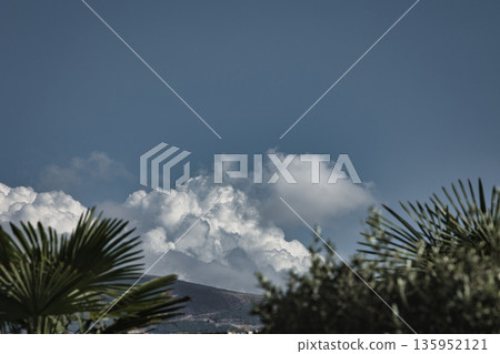 A sweeping mountain landscape in August 2025, with tiered, wooded hills under a clear summer sky. A sweeping mountain landscape in August 2025, with tiered, wooded hills under a clear summer sky. 135952121