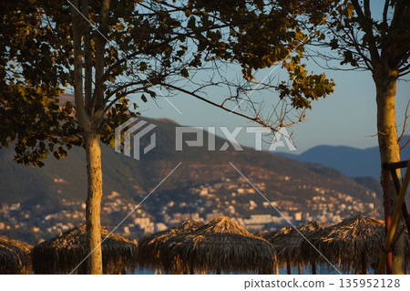 A sweeping mountain landscape in August 2025, with tiered, wooded hills under a clear summer sky. A sweeping mountain landscape in August 2025, with tiered, wooded hills under a clear summer sky. 135952128
