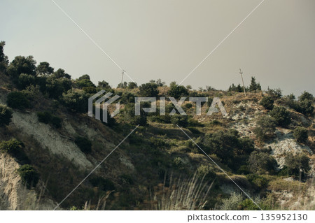 A sweeping mountain landscape in August 2025, with tiered, wooded hills under a clear summer sky. 135952130