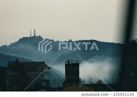 A sweeping mountain landscape in August 2025, with tiered, wooded hills under a clear summer sky. A sweeping mountain landscape in August 2025, with tiered, wooded hills under a clear summer sky. 135952139