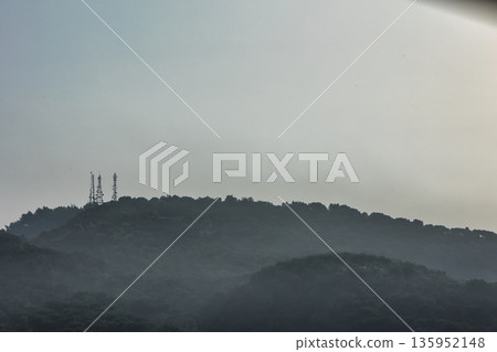 A sweeping mountain landscape in August 2025, with tiered, wooded hills under a clear summer sky. A sweeping mountain landscape in August 2025, with tiered, wooded hills under a clear summer sky. 135952148