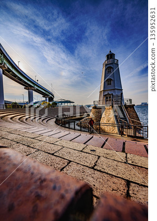 The old Sakai Lighthouse and the port town scenery of Sakai, shining against the blue sky 135952631