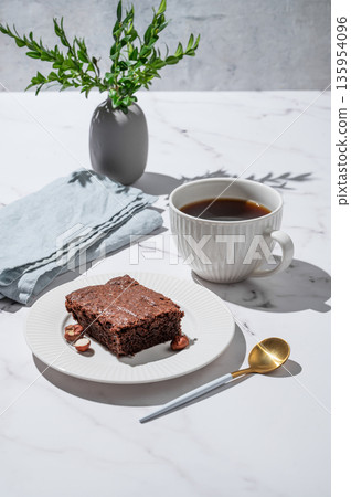 Pieces of chocolate brownie on a plate and a cup of espresso coffee on a marble background 135954096