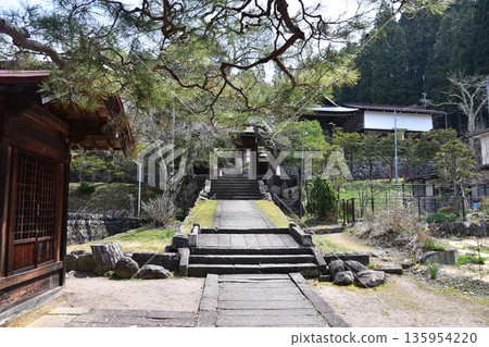 Old townscape of Takayama city, Gifu prefecture, Japan. Retro temple on Higashiyama promenade. Deep Japanese wooden architecture and stone steps. 135954220