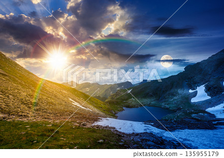 mountain lake in alpine summer landscape. day and night time change concept. beautiful view surrounded with sun and moon at twilight. fresh water, snow and rocky slopes. remote highlands adventures mountain lake in alpine summer landscape. day and night time change concept. beautiful view surrounded with sun and moon at twilight. fresh water, snow and rocky slopes. remote highlands adventures 135955179