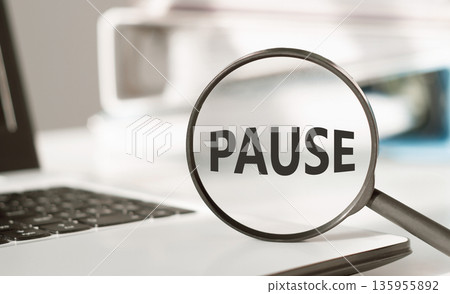 Magnifying glass with the word PAUSE on office background Magnifying glass with the word PAUSE on office background 135955892