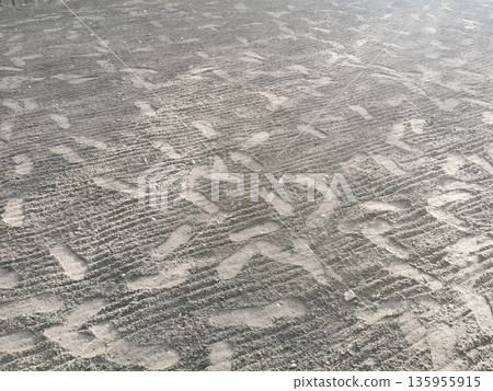 Plowed field with footprints, background photo texture Plowed field with footprints, background photo texture 135955915