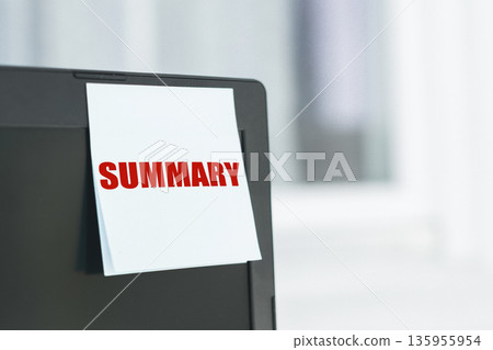 A White Sticky Note With Red Summary Text on a Black Laptop A White Sticky Note With Red Summary Text on a Black Laptop 135955954