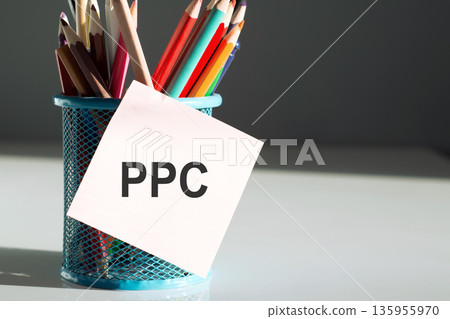 Stickers with pencils with text PPC on the white table background Stickers with pencils with text PPC on the white table background 135955970