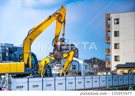 Hydraulic crusher at a building demolition construction site Hydraulic crusher at a building demolition construction site 135955977
