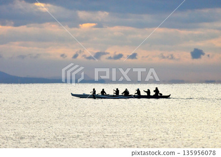 SUP and canoe paddlers in the morning glow on New Year's Day SUP and canoe paddlers in the morning glow on New Year's Day 135956078
