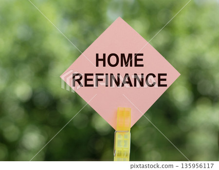 HOME REFINANCE phrase written on a pink traffic sign on blurred green background. HOME REFINANCE phrase written on a pink traffic sign on blurred green background. 135956117