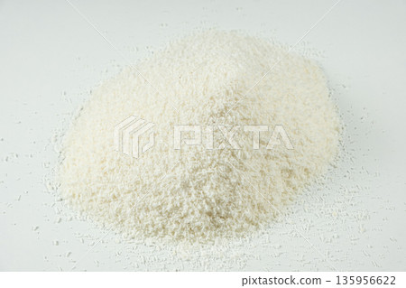 Pile of coconut flakes on white background macro Pile of coconut flakes on white background macro 135956622