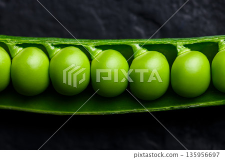 Close up of fresh green peas in pod showing natural texture Close up of fresh green peas in pod showing natural texture 135956697