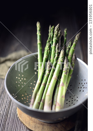 Green asparagus stalks placed inside metal strainer Green asparagus stalks placed inside metal strainer 135956801