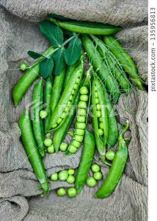 Green peas scattered on fabric surface Green peas scattered on fabric surface 135956813