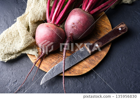 Raw beetroot with stems on cutting board ready for cooking 135956830