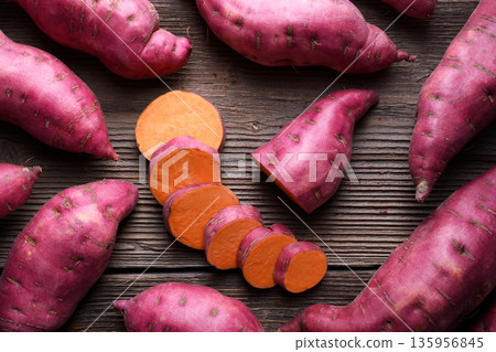Sweet potato slices surrounded by whole tubers Sweet potato slices surrounded by whole tubers 135956845