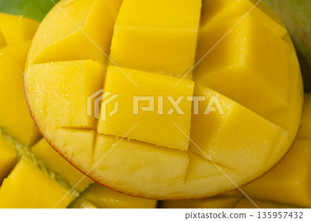 Juicy mango halves with cube cut pattern. Juicy mango halves with cube cut pattern. 135957432