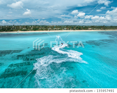 Aerial view of jet skis over shallow turquoise sea with reef Aerial view of jet skis over shallow turquoise sea with reef 135957491