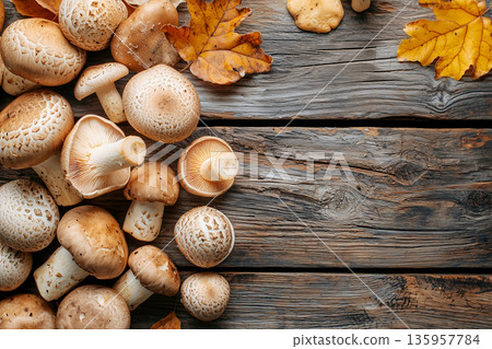 Close-up autumn mushrooms spread across wooden table, surrounded by vibrant autumn leaves and copy space. Warmth fall, organic food, culinary creations, and rustic cooking inspiration. 135957784